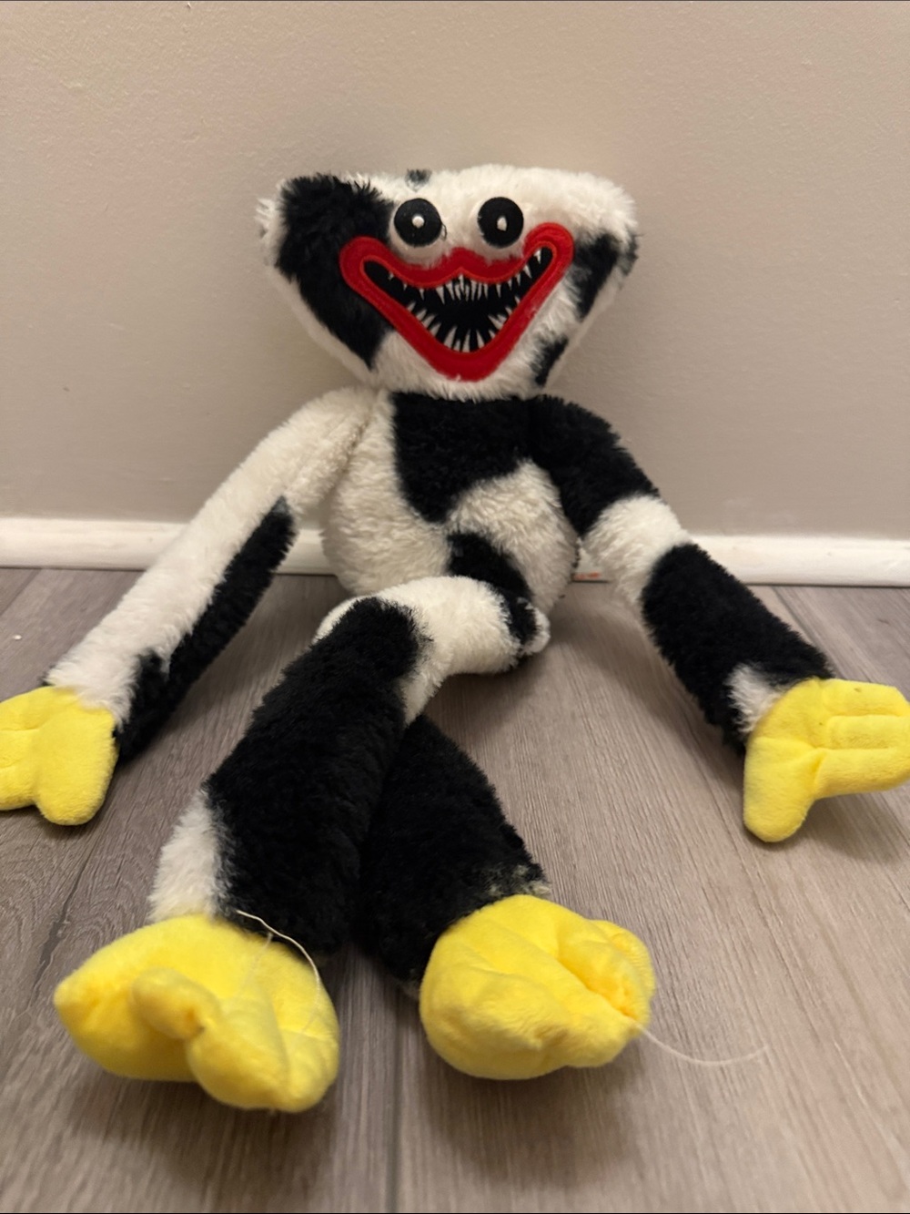 Black & White Plush Character Toy with Yellow Hands and Feet